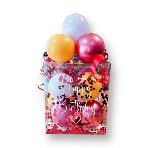 Geschenkbox mit Luftballons in mustard, chrom pomegranate, violett & pastellflieder
